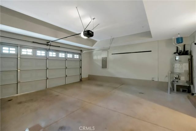 garage featuring water heater, electric panel, and a garage door opener