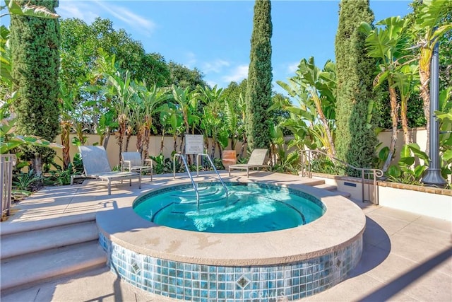 view of pool featuring a patio area, a hot tub, and fence