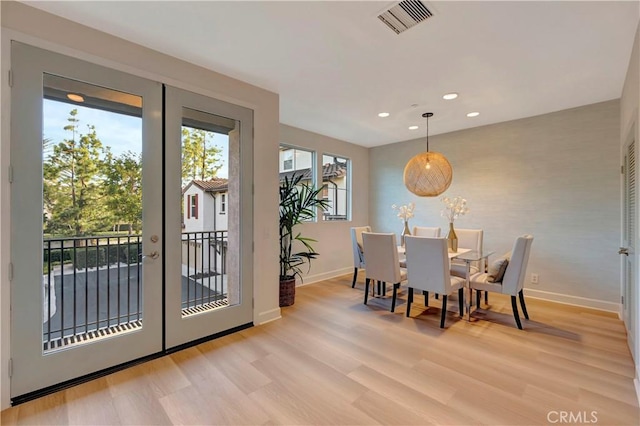 dining room featuring visible vents, baseboards, light wood-style flooring, french doors, and recessed lighting