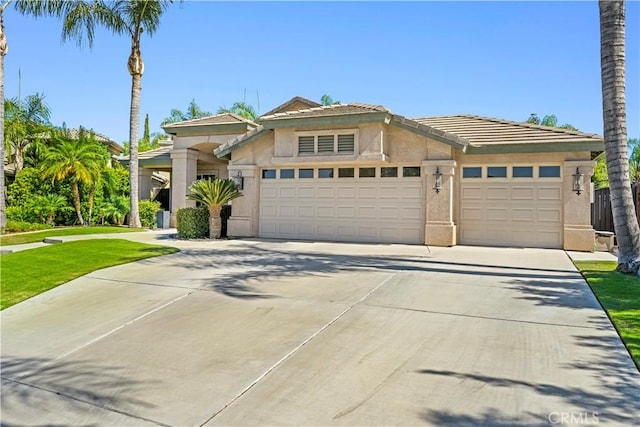 view of front of house featuring a garage and a front lawn