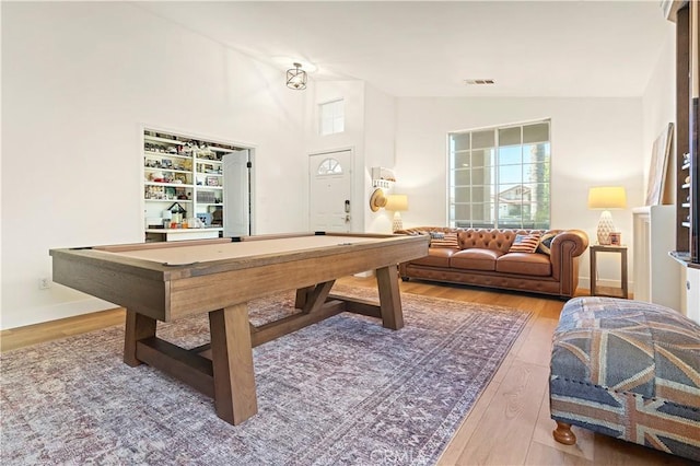 game room featuring hardwood / wood-style floors, billiards, and high vaulted ceiling