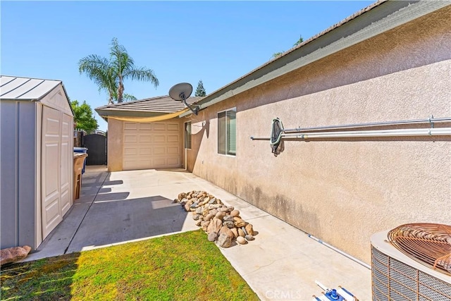 view of side of home featuring a garage and central AC