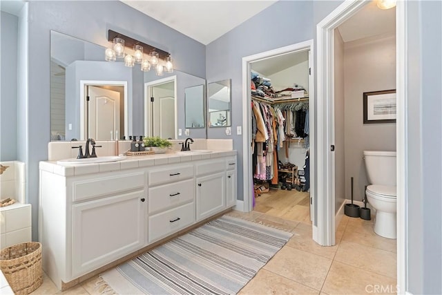 bathroom with vanity, tile patterned flooring, and toilet