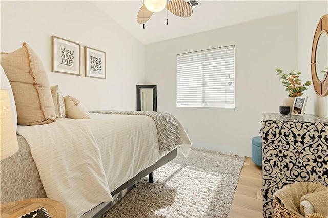 bedroom featuring vaulted ceiling, ceiling fan, and light wood-type flooring