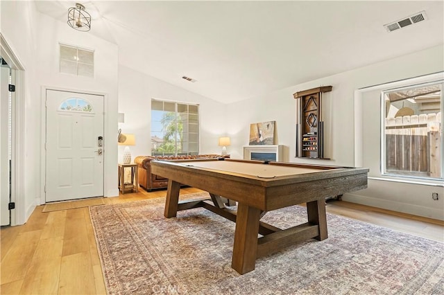 rec room featuring vaulted ceiling and light wood-type flooring