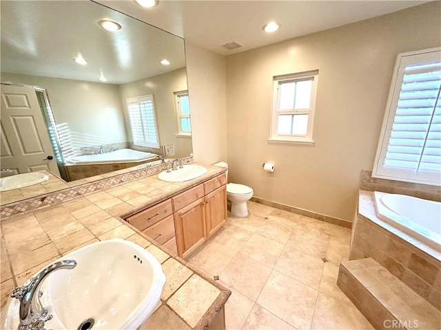 bathroom with a sink, a garden tub, and double vanity