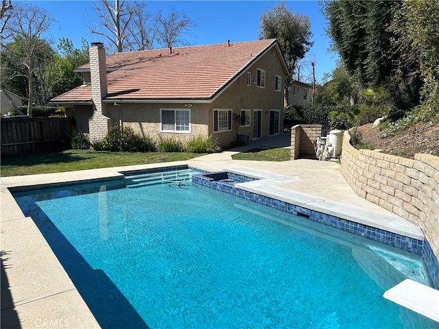 view of pool with a lawn, a patio, fence, a diving board, and a fenced in pool