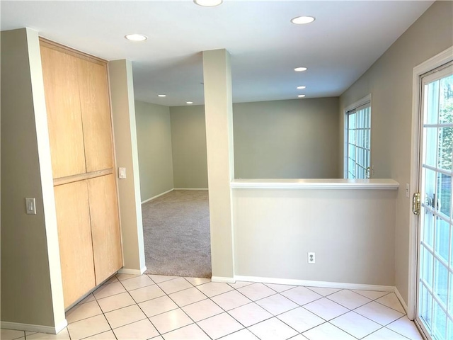 unfurnished room featuring light tile patterned flooring, recessed lighting, and baseboards