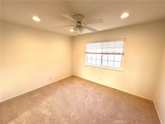 carpeted spare room featuring recessed lighting, baseboards, and ceiling fan