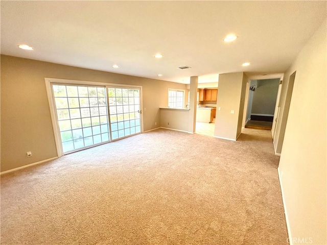 unfurnished living room featuring recessed lighting, visible vents, baseboards, and light colored carpet