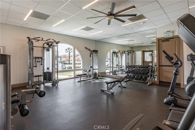 gym featuring a paneled ceiling and ceiling fan