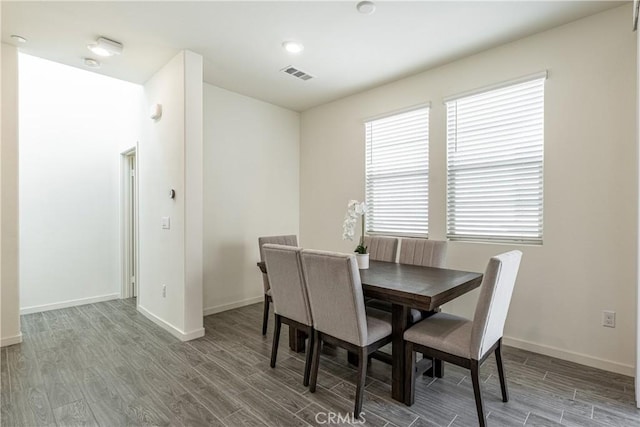 dining room featuring hardwood / wood-style flooring and a healthy amount of sunlight