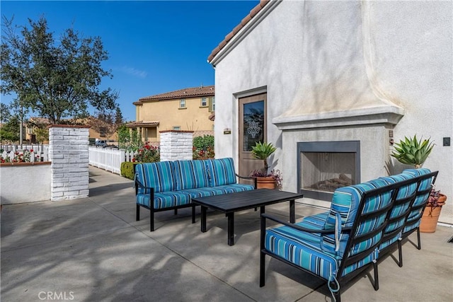 view of patio / terrace featuring an outdoor living space with a fireplace