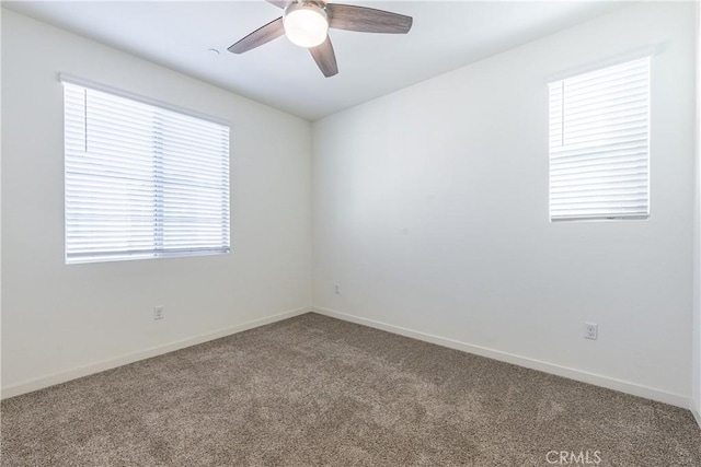 spare room with carpet floors and ceiling fan