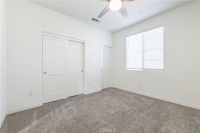 unfurnished bedroom featuring a closet, ceiling fan, and carpet