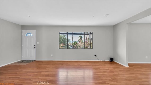 entrance foyer featuring light wood-type flooring and baseboards