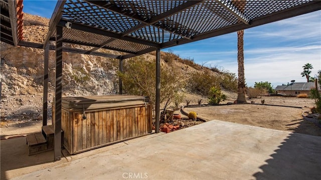 view of patio / terrace featuring a hot tub and a pergola