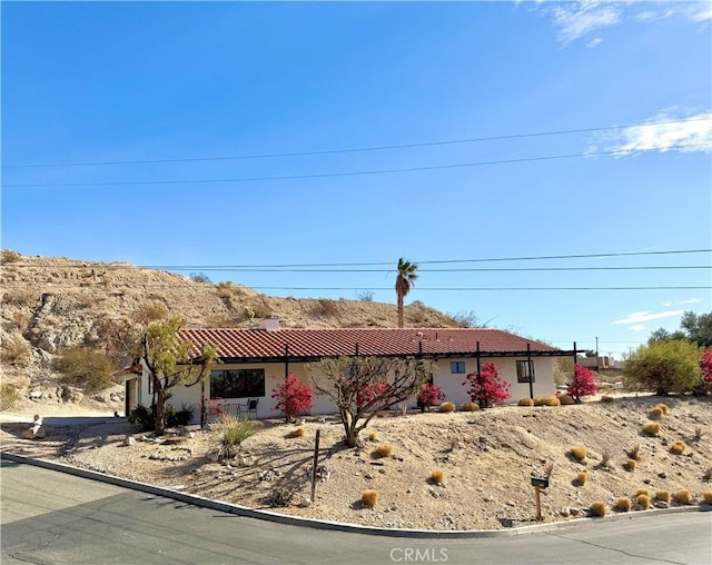 ranch-style house featuring stucco siding