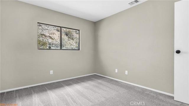 carpeted spare room featuring visible vents and baseboards