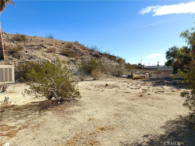 view of yard featuring central AC unit and fence