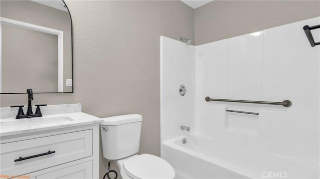 bathroom with shower / washtub combination, vanity, and toilet