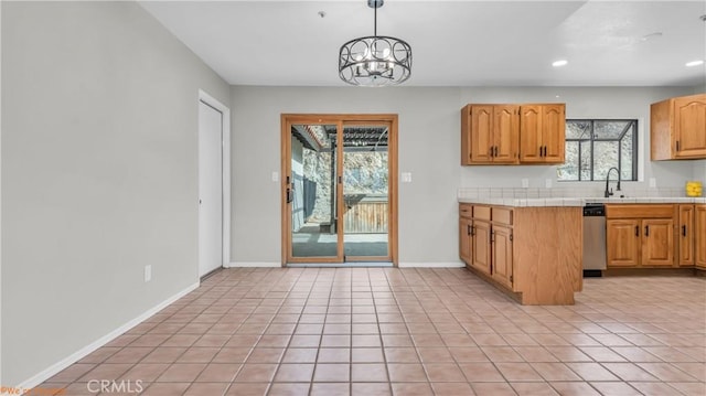 kitchen featuring hanging light fixtures, recessed lighting, baseboards, and light tile patterned flooring