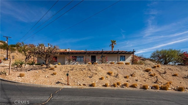 ranch-style house featuring stucco siding