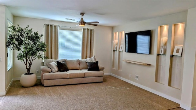 living room with ceiling fan and carpet flooring