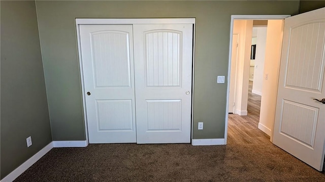 unfurnished bedroom with carpet and a closet