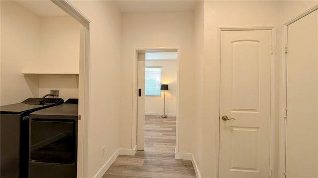 hallway with light hardwood / wood-style floors