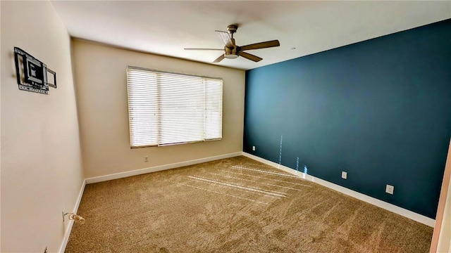 empty room featuring carpet floors and ceiling fan