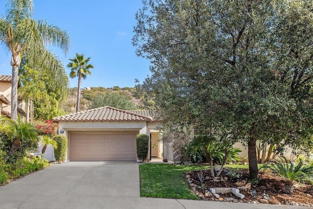 mediterranean / spanish-style home with a garage