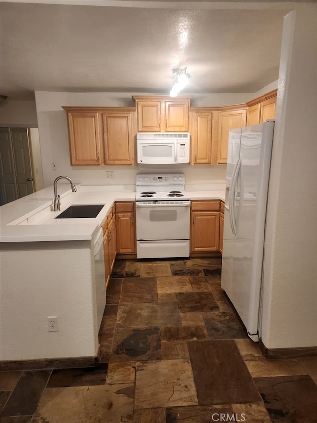 kitchen featuring sink, white appliances, kitchen peninsula, and light brown cabinets