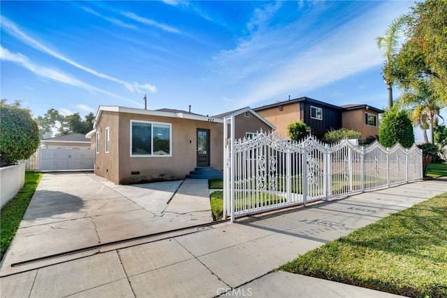 ranch-style house featuring a gate, fence private yard, crawl space, and stucco siding