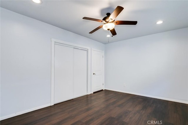 unfurnished bedroom with dark wood finished floors and baseboards