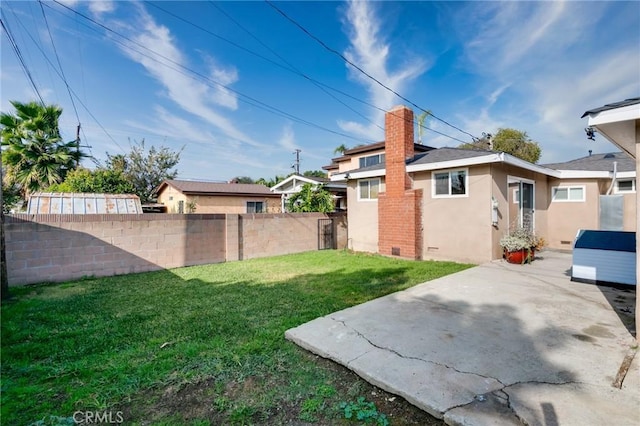 view of yard featuring fence and a patio