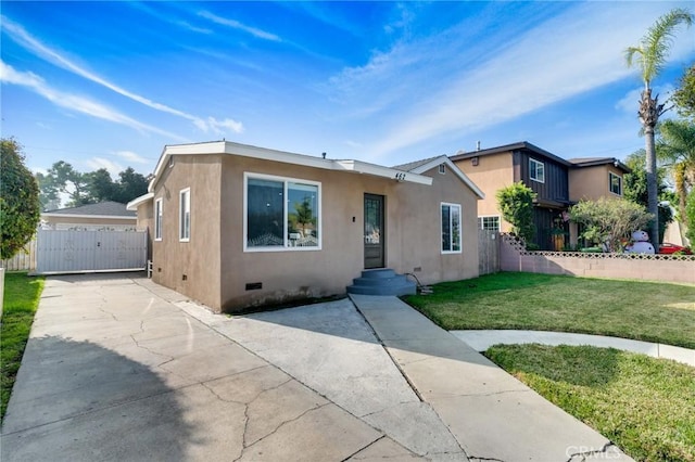 view of front of house with fence, crawl space, a front lawn, and stucco siding