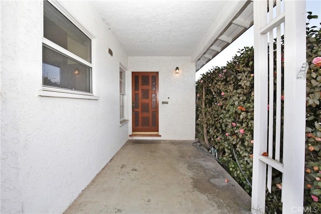 doorway to property with stucco siding