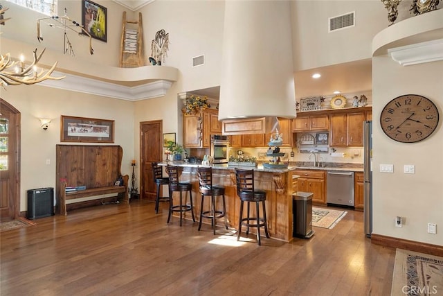 41700 Jojoba Hills Cir, Aguanga, CA 92536 - kitchen featuring appliances with stainless steel finishes, dark hardwood / wood-style floors, sink, a kitchen bar, and kitchen peninsula