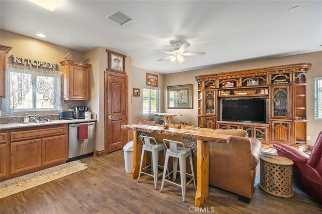 41700 Jojoba Hills Cir, Aguanga, CA 92536 - kitchen featuring sink, dishwasher, ceiling fan, a kitchen breakfast bar, and dark hardwood / wood-style flooring