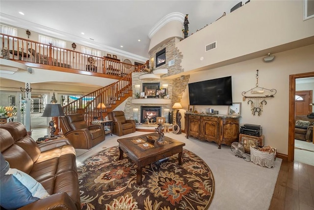41700 Jojoba Hills Cir, Aguanga, CA 92536 - living room featuring hardwood / wood-style flooring, crown molding, a towering ceiling, and a fireplace