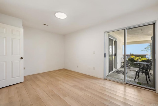 unfurnished room with light wood-type flooring