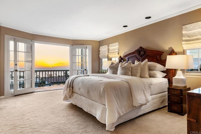 carpeted bedroom featuring crown molding, access to outside, and french doors