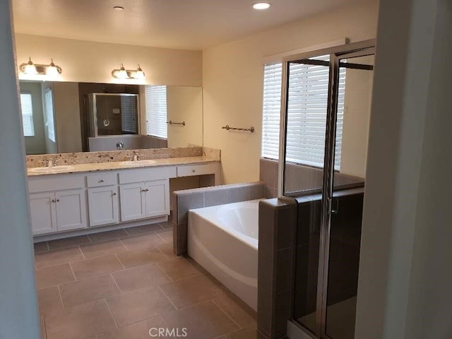 bathroom with vanity, shower with separate bathtub, tile patterned flooring, and plenty of natural light