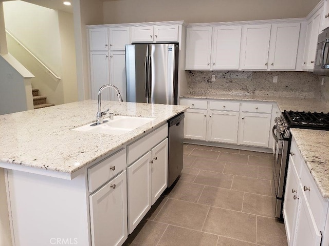 kitchen with a kitchen island with sink, sink, white cabinetry, and stainless steel appliances