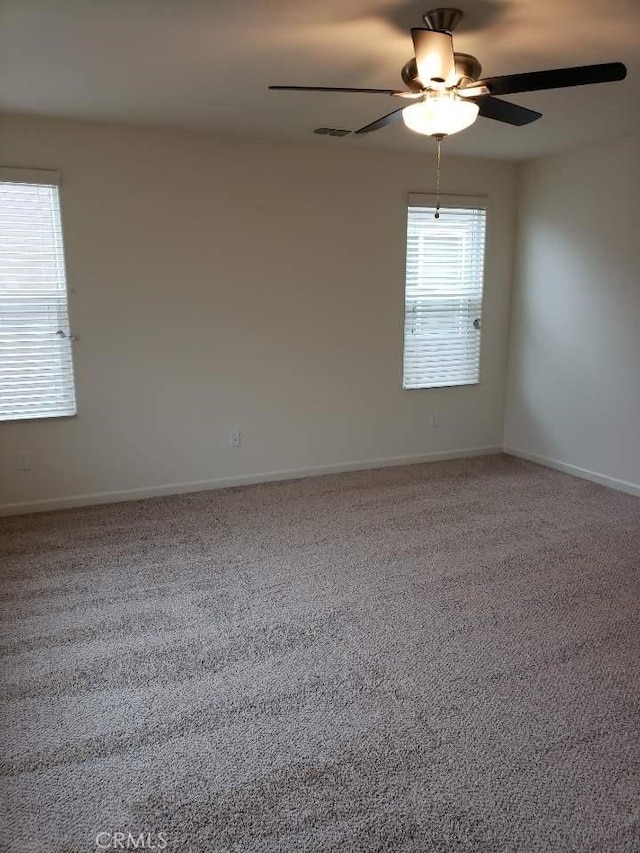 carpeted empty room featuring ceiling fan