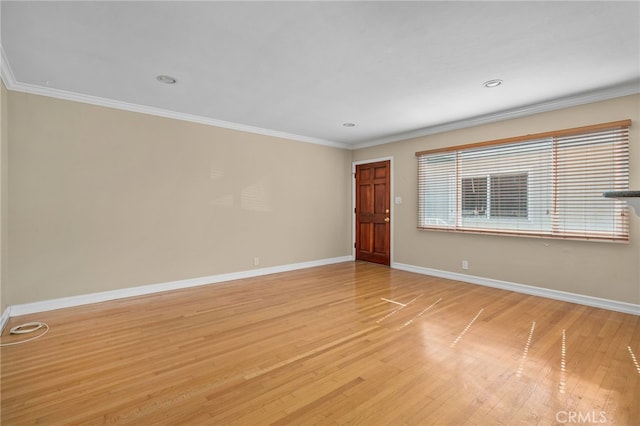 unfurnished room with crown molding and light hardwood / wood-style floors