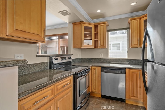 kitchen featuring ornamental molding, stainless steel appliances, and dark stone counters