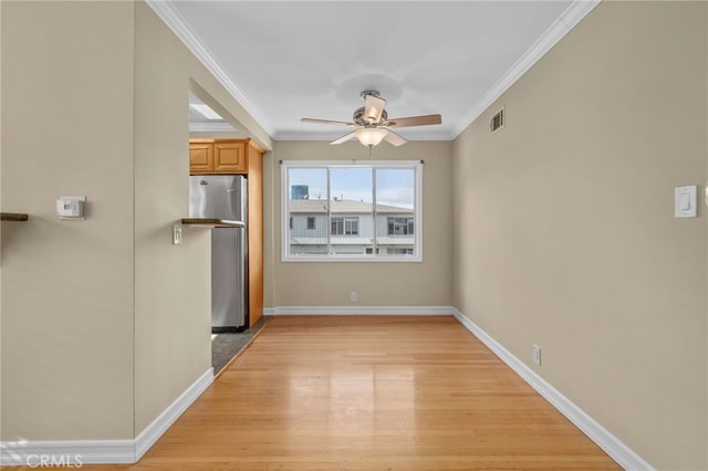 interior space featuring ornamental molding, ceiling fan, stainless steel refrigerator, and light hardwood / wood-style floors