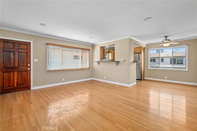 unfurnished living room featuring ceiling fan, ornamental molding, and light hardwood / wood-style floors